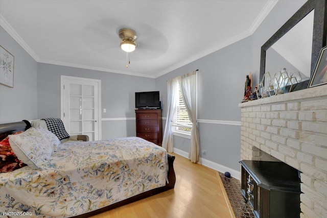 25 E 150th St, Harvey, IL 60426 - bedroom featuring wood finished floors, crown molding, a brick fireplace, and a ceiling fan