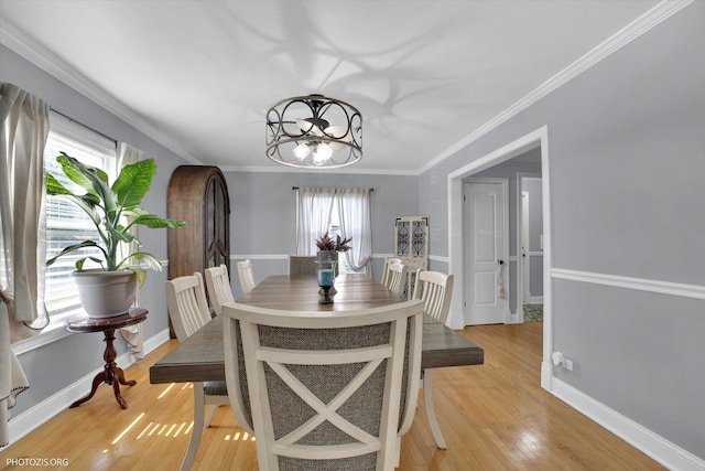 25 E 150th St, Harvey, IL 60426 - dining room with a chandelier, light wood-style flooring, and crown molding