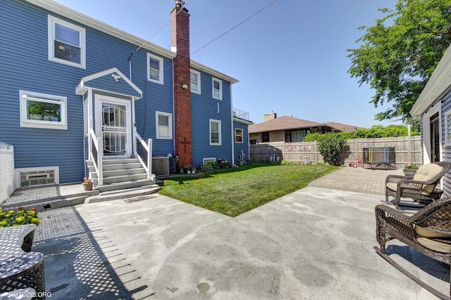 25 E 150th St, Harvey, IL 60426 - rear view of house featuring a chimney, a patio area, and entry steps