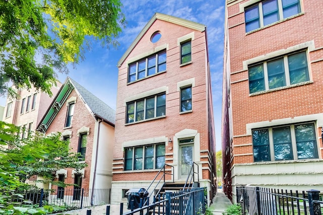 2136 W Schiller St Unit 1R, Chicago, IL 60622 - multi unit property with a fenced front yard, entry steps, and brick siding