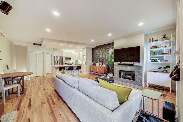 2136 W Schiller St Unit 1R, Chicago, IL 60622 - living area featuring ornamental molding, a fireplace, light wood-style flooring, and recessed lighting