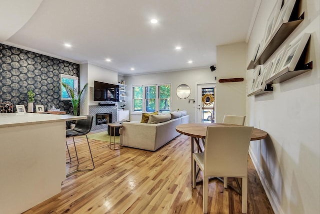 2136 W Schiller St Unit 1R, Chicago, IL 60622 - living area featuring light wood-style floors, wallpapered walls, an accent wall, a glass covered fireplace, and recessed lighting