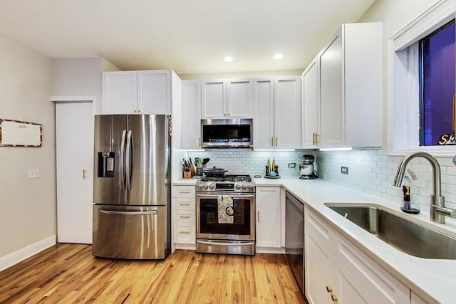 2136 W Schiller St Unit 1R, Chicago, IL 60622 - kitchen featuring stainless steel appliances, light countertops, backsplash, light wood-style flooring, and white cabinets