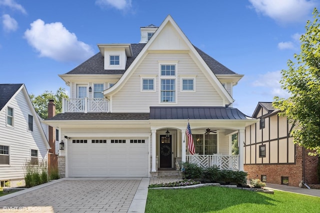 4603 Oakwood Ave, Downers Grove, IL 60515 - view of front of home featuring covered porch, a standing seam roof, decorative driveway, a garage, and a front lawn