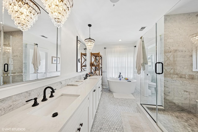 4603 Oakwood Ave, Downers Grove, IL 60515 - full bath with a chandelier, double vanity, a freestanding bath, a shower stall, and tile walls