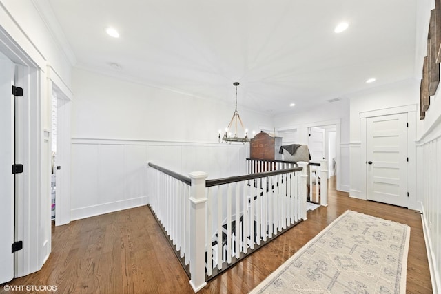 4603 Oakwood Ave, Downers Grove, IL 60515 - hallway featuring an upstairs landing, a wainscoted wall, a chandelier, wood finished floors, and crown molding