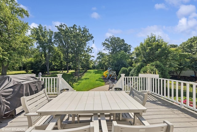 4603 Oakwood Ave, Downers Grove, IL 60515 - deck with outdoor dining area, a yard, view of scattered trees, and a grill