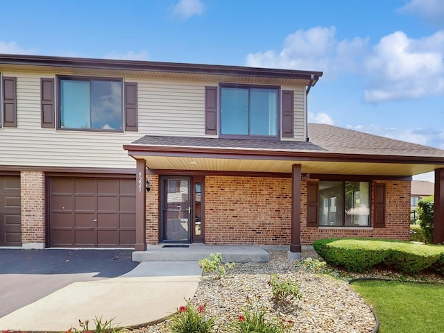 9221 Auburn Ct, Orland Park, IL 60462 - view of front facade with brick siding, covered porch, an attached garage, and driveway