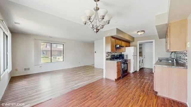 9221 Auburn Ct, Orland Park, IL 60462 - kitchen with gas stove, open floor plan, range hood, dark wood-type flooring, and decorative backsplash