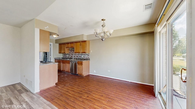 9221 Auburn Ct, Orland Park, IL 60462 - kitchen with stainless steel dishwasher, a chandelier, dark wood-type flooring, backsplash, and brown cabinetry