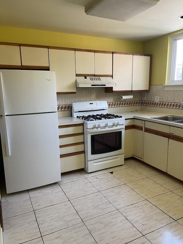 1027 W Vernon Park Pl Unit B, Chicago, IL 60607 - kitchen featuring white appliances, custom range hood, light countertops, cream cabinets, and backsplash