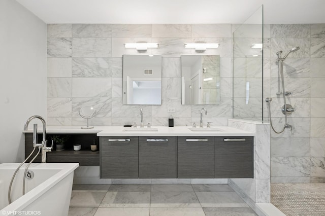 1018 N Larrabee St Unit 5S, Chicago, IL 60610 - full bathroom featuring double vanity, a soaking tub, walk in shower, marble look tiles, and tile walls