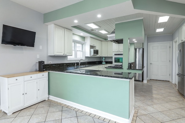 15442 W Purley Ct, Homer Glen, IL 60491 - kitchen featuring stainless steel appliances, a peninsula, light tile patterned floors, white cabinets, and dark stone counters