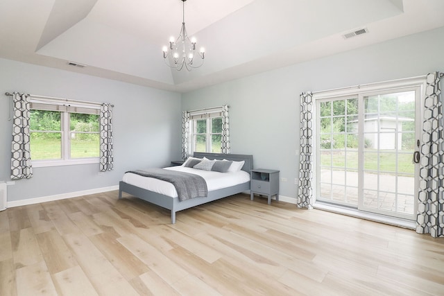 15442 W Purley Ct, Homer Glen, IL 60491 - bedroom featuring a chandelier, access to outside, light wood finished floors, and multiple windows
