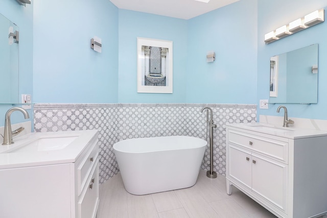15442 W Purley Ct, Homer Glen, IL 60491 - bathroom with a wainscoted wall, two vanities, a soaking tub, and tile walls