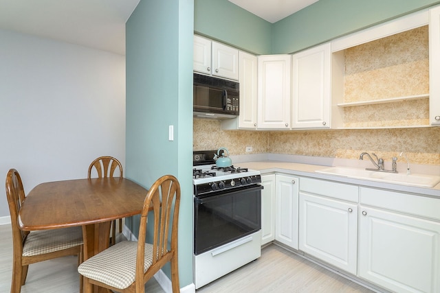 15442 W Purley Ct, Homer Glen, IL 60491 - kitchen featuring white range with gas cooktop, black microwave, light countertops, and tasteful backsplash