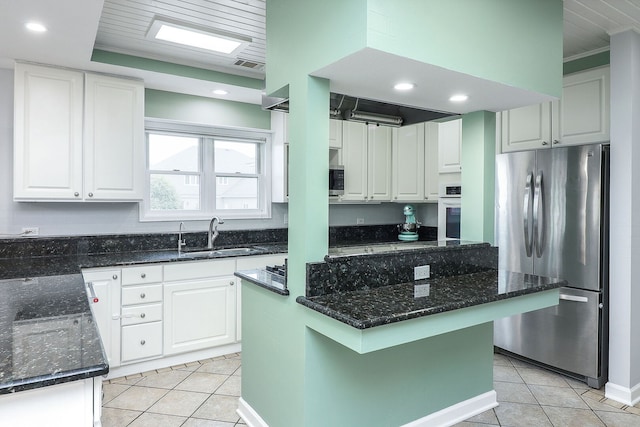 15442 W Purley Ct, Homer Glen, IL 60491 - kitchen with appliances with stainless steel finishes, light tile patterned floors, dark stone counters, white cabinetry, and recessed lighting