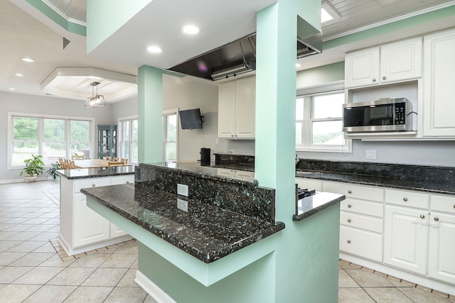 15442 W Purley Ct, Homer Glen, IL 60491 - kitchen with stainless steel microwave, a kitchen island, light tile patterned floors, healthy amount of natural light, and recessed lighting