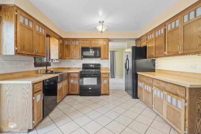 658 Brookside Ln, Frankfort, IL 60423 - kitchen with black appliances, light countertops, light tile patterned floors, and brown cabinetry