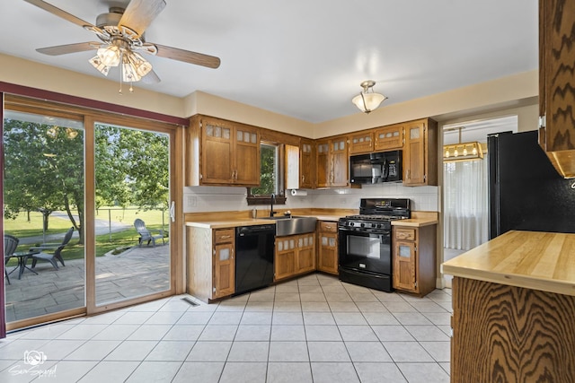 658 Brookside Ln, Frankfort, IL 60423 - kitchen with black appliances, light countertops, light tile patterned floors, and plenty of natural light