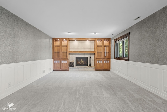 658 Brookside Ln, Frankfort, IL 60423 - unfurnished living room with a tiled fireplace, a wainscoted wall, carpet floors, and a decorative wall