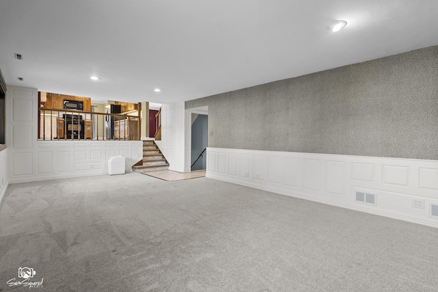 658 Brookside Ln, Frankfort, IL 60423 - unfurnished living room featuring carpet floors, stairs, recessed lighting, a decorative wall, and wainscoting