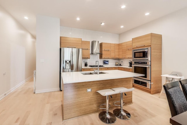922 N Hermitage Ave Unit 1, Chicago, IL 60622 - kitchen featuring appliances with stainless steel finishes, wall chimney exhaust hood, light countertops, a warming drawer, and modern cabinets
