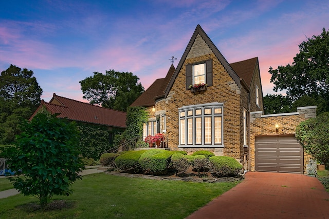 400 Selborne Rd, Riverside, IL 60546 - english style home featuring a garage, driveway, a front yard, and brick siding