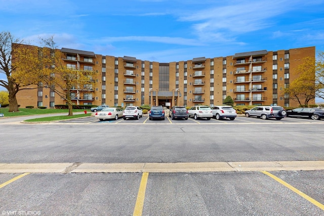 900 W Sunset Dr Unit 405, Glenwood, IL 60425 - view of apartment building / complex featuring uncovered parking