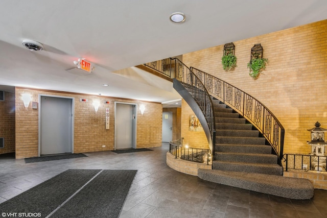 900 W Sunset Dr Unit 405, Glenwood, IL 60425 - community lobby featuring brick wall and stairway