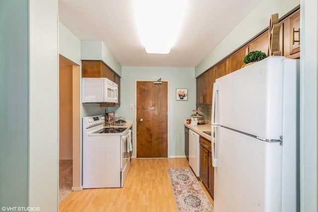 900 W Sunset Dr Unit 405, Glenwood, IL 60425 - kitchen with white appliances, light wood-style flooring, light countertops, and brown cabinetry