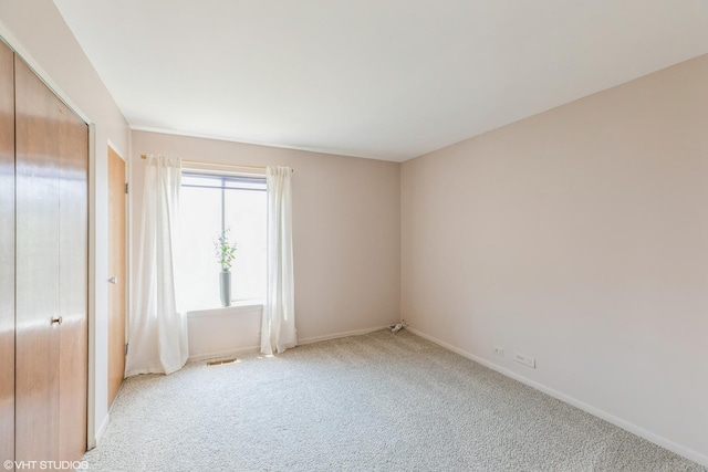 900 W Sunset Dr Unit 405, Glenwood, IL 60425 - unfurnished bedroom with light carpet and baseboards