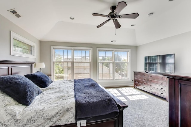 6067 N Oconto Ave, Chicago, IL 60631 - carpeted bedroom with multiple windows, vaulted ceiling, ceiling fan, and a tray ceiling