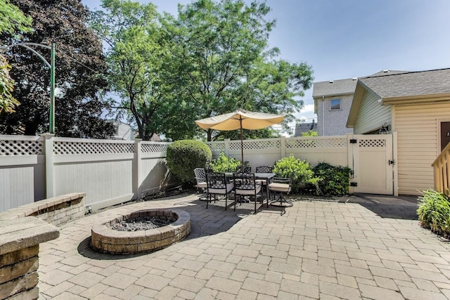 6067 N Oconto Ave, Chicago, IL 60631 - fenced backyard featuring an outdoor fire pit, a patio area, a gate, and outdoor dining area