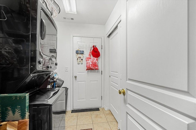 93 W Essington Dr Unit 93, Round Lake, IL 60073 - laundry area featuring stacked washer / drying machine and light tile patterned floors