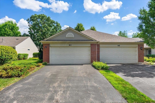 93 W Essington Dr Unit 93, Round Lake, IL 60073 - view of front of property featuring brick siding, asphalt driveway, and a garage