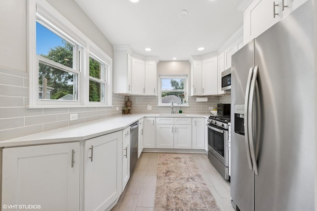 588 Glendale Ave, Glen Ellyn, IL 60137 - kitchen with appliances with stainless steel finishes, white cabinetry, tasteful backsplash, recessed lighting, and light countertops