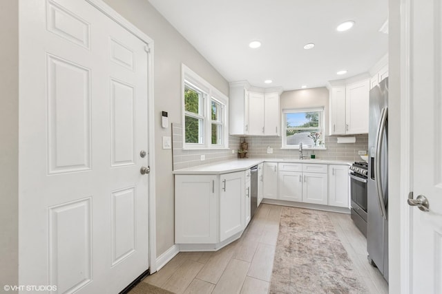 588 Glendale Ave, Glen Ellyn, IL 60137 - kitchen with appliances with stainless steel finishes, backsplash, white cabinets, light countertops, and recessed lighting