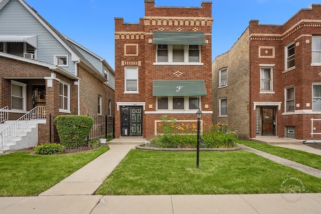 1246 N Monitor Ave, Chicago, IL 60651 - view of front of property featuring brick siding and a front yard