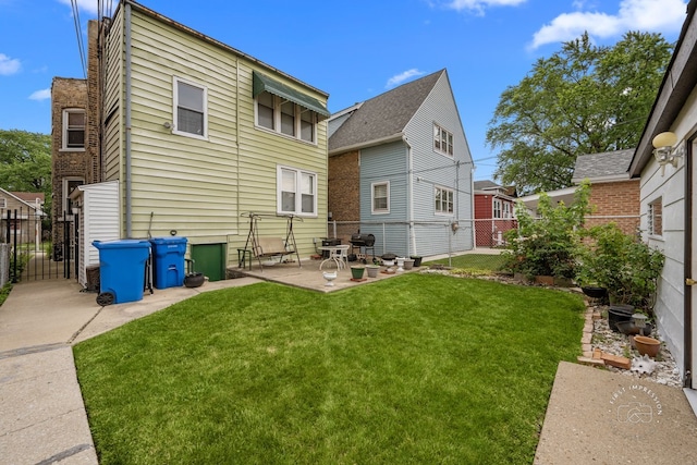 1246 N Monitor Ave, Chicago, IL 60651 - rear view of house featuring a patio area, a fenced backyard, and a gate