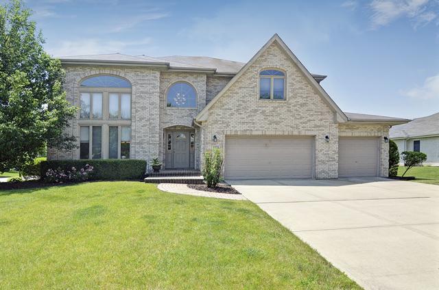 2301 Kerry Ln, Darien, IL 60561 - french country home with brick siding, a front yard, driveway, and an attached garage