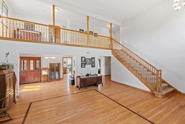 2301 Kerry Ln, Darien, IL 60561 - living room featuring a chandelier, stairs, wood finished floors, and a high ceiling