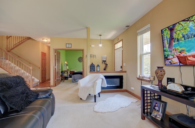 381 Chesapeake Ln, Oswego, IL 60543 - living room with carpet, stairway, and a glass covered fireplace