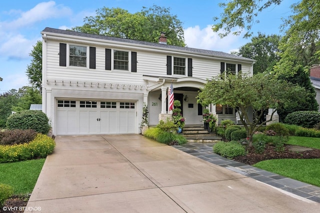 261 Woodstock Ave, Glen Ellyn, IL 60137 - view of front of house featuring an attached garage, a porch, driveway, and a chimney