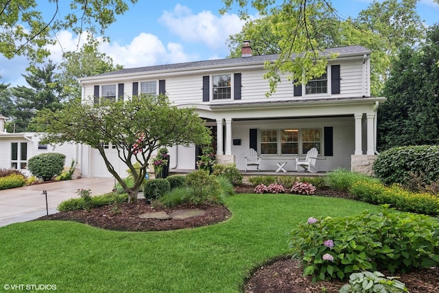 261 Woodstock Ave, Glen Ellyn, IL 60137 - view of front facade featuring concrete driveway, a porch, a chimney, a front lawn, and a garage