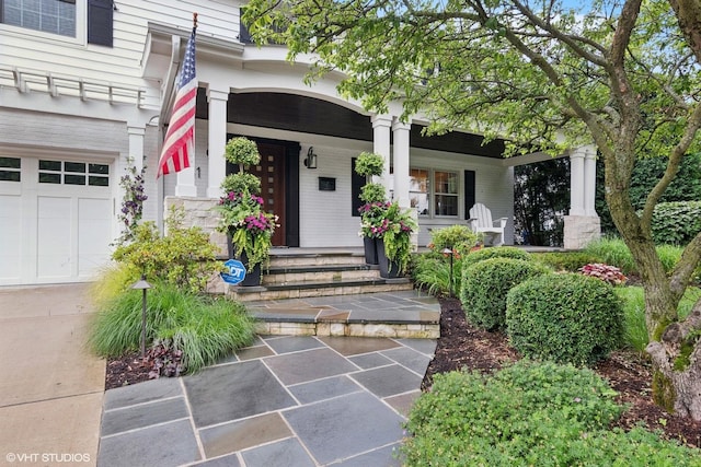 261 Woodstock Ave, Glen Ellyn, IL 60137 - doorway to property featuring a porch, brick siding, and a garage