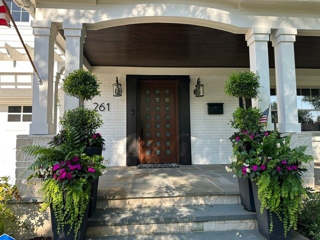 261 Woodstock Ave, Glen Ellyn, IL 60137 - view of exterior entry with brick siding and covered porch