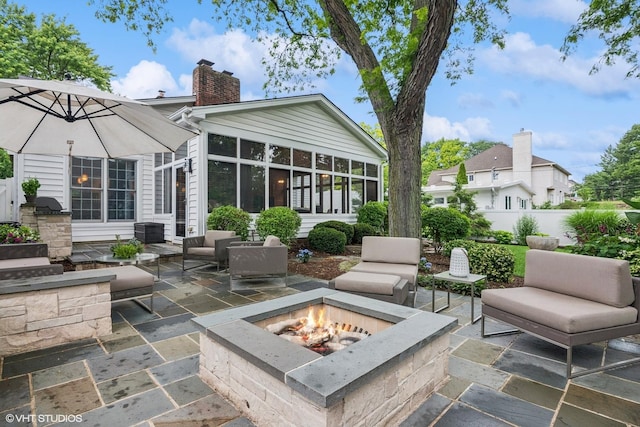 261 Woodstock Ave, Glen Ellyn, IL 60137 - view of patio / terrace with an outdoor fire pit and a sunroom