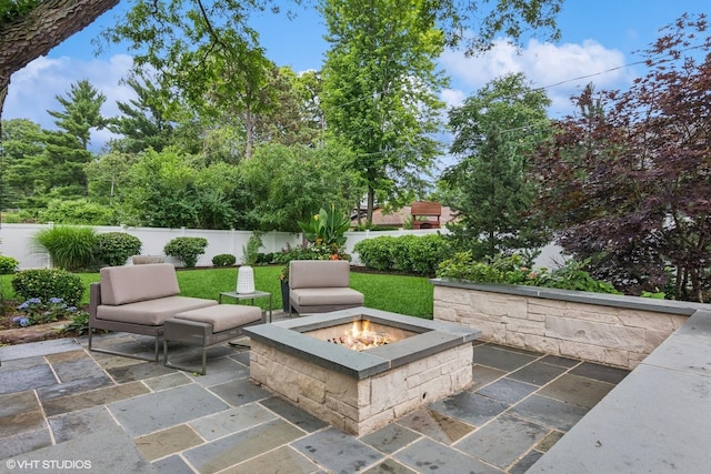 261 Woodstock Ave, Glen Ellyn, IL 60137 - fenced backyard with an outdoor fire pit and a patio area