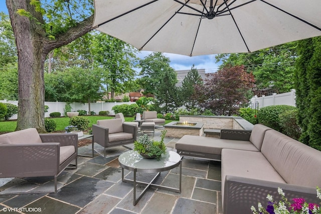 261 Woodstock Ave, Glen Ellyn, IL 60137 - fenced backyard featuring an outdoor living space with a fire pit and a patio area